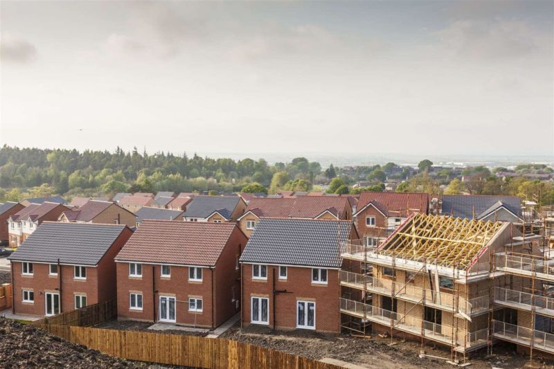 An image of housebuilding with trees in the background